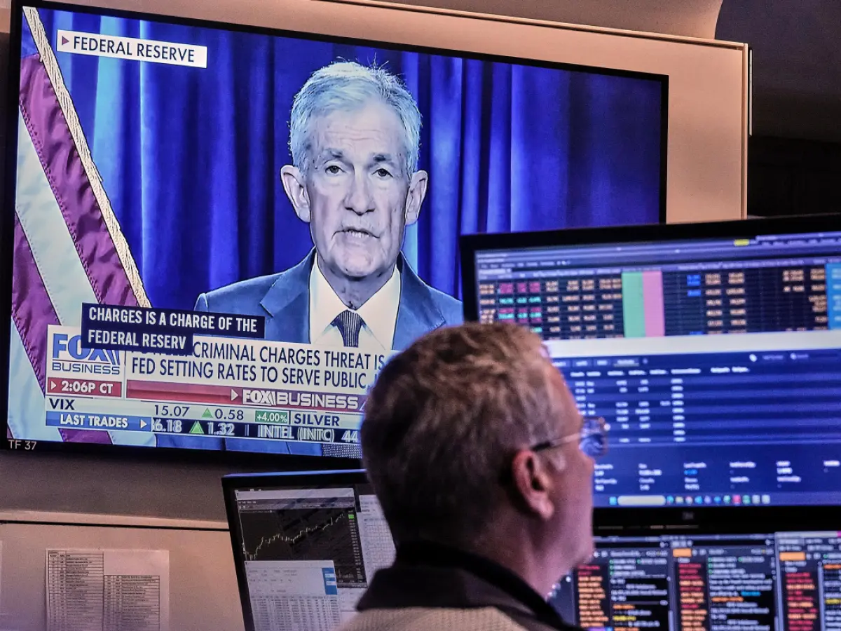 Trader watching Federal Reserve announcement on Bloomberg terminal with market chart showing volatility